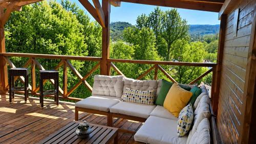 a couch on a porch with a view of trees at Guest House Kandaferi 2 in Elena
