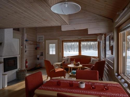 a living room with a couch and a table at Polar Tranquil Cabins in Kittilä