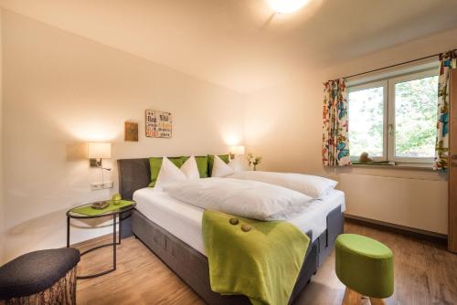 a bedroom with a large bed and a window at Bayern Resort - Apartments & Wellness in Grainau