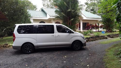 a white van parked in front of a house at Tropical Paradise Bungalows in Pital