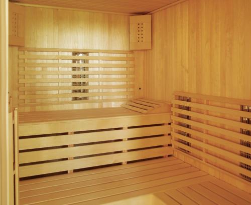 a sauna with wooden walls and a wooden floor at Villa Alma Vista in Dobrovo
