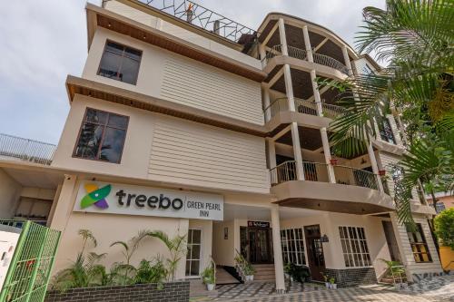 a building with a treeazon sign in front of it at Treebo Green Pearl Inn in Guwahati