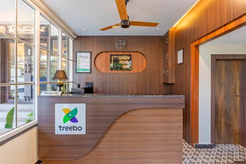 a hotel lobby with a treeoco sign on a counter at Treebo Green Pearl Inn in Guwahati