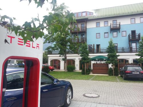 a blue car parked in front of a building at Alphotel Innsbruck in Innsbruck