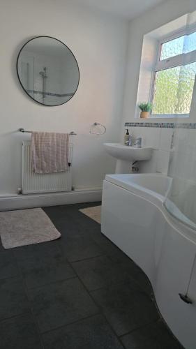 a white bathroom with a sink and a mirror at Balfour house III in Leicester
