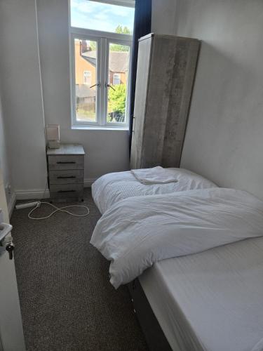 a bedroom with two beds and a window at Balfour house III in Leicester
