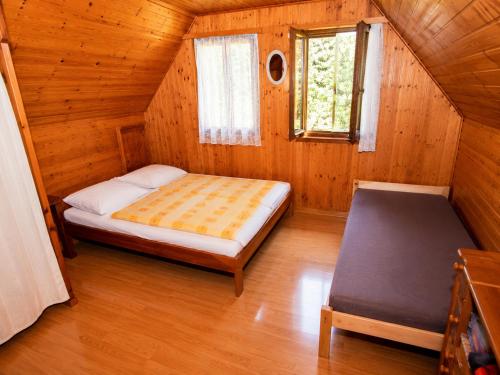 a small bedroom with a bed and a window at Chata Růžová in Růžová