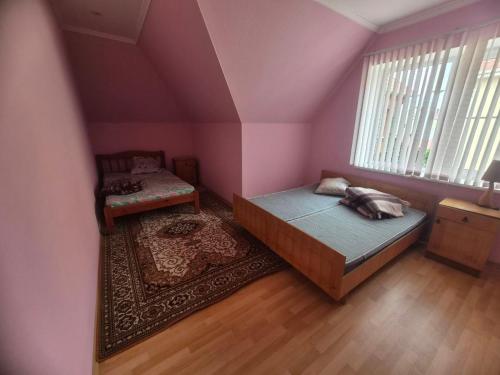 a bedroom with a bed and a chair and a window at Full relax in Zatoka