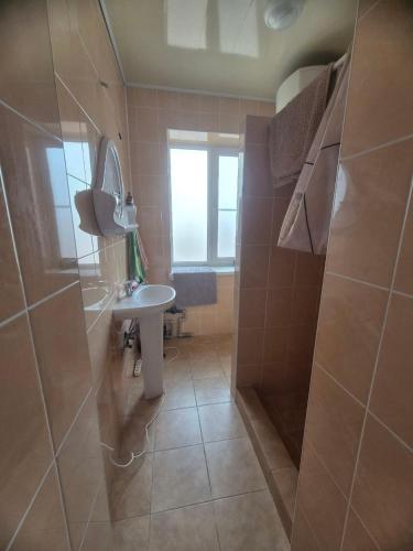 a bathroom with a sink and a toilet and a window at Full relax in Zatoka