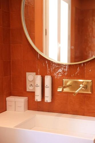 a bathroom with a sink and a mirror at Hôtel Casa Elena in Erbalunga