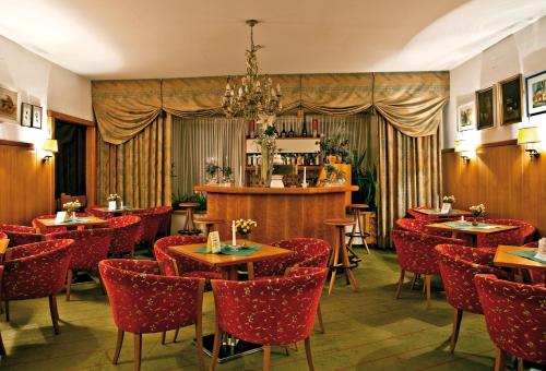 a restaurant with tables and chairs and a chandelier at Appartement & Aparthotel Stern in Imst