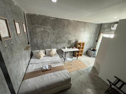 a room with a bed and a table in it at Bird Nest in Ko Tao