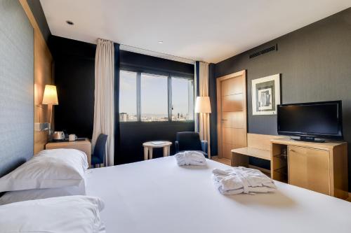 Postel nebo postele na pokoji v ubytování Hotel Barcelona Universal