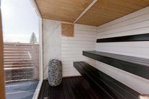 a sauna with a bench on a wooden deck at Rooftop Spa Villa Kuressaare in Kuressaare