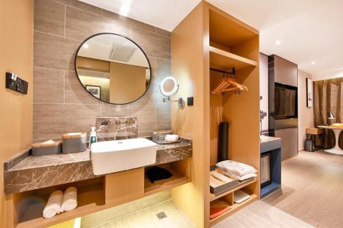 a bathroom with a sink and a mirror at Atour S Hotel Beijing Anzhen in Beijing