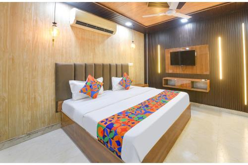 a bedroom with a large bed and a tv at Via The Akshardham Bliss - LAXMI NAGAR METRO in New Delhi