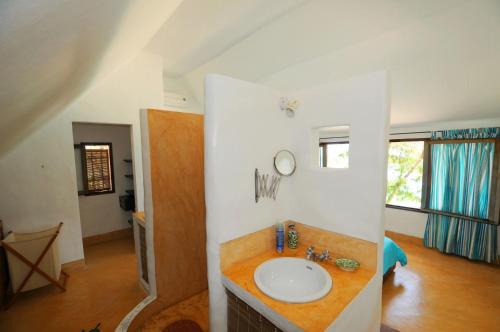 a bathroom with a sink in a room at Villa Isabella in Trou dʼ Eau Douce