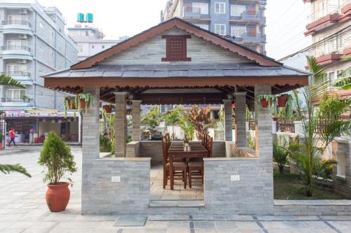 a gazebo with a table and chairs at Hotel White Pearl in Pokhara