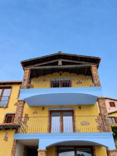 a yellow building with a balcony at Villa Maris in Nebida