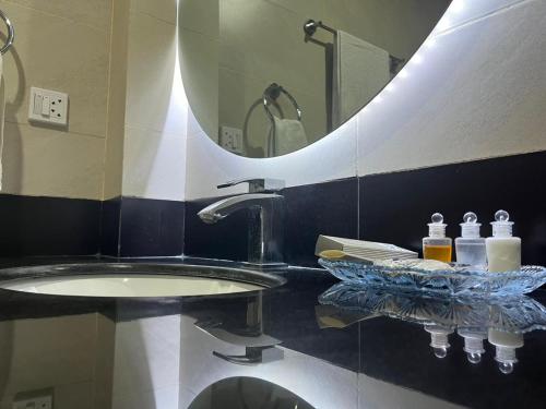 a bathroom with a sink and a large mirror at Hispar Hotel Skardu in Skardu