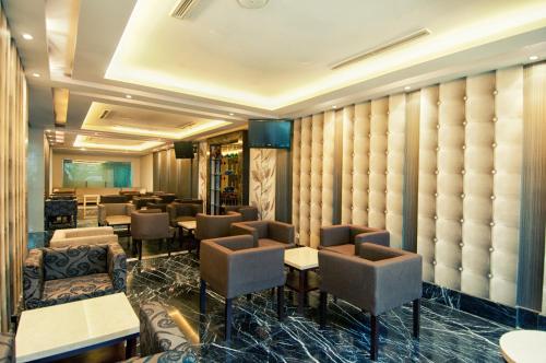 a restaurant with chairs and tables in a room at Grand Sakura Hotel in Medan