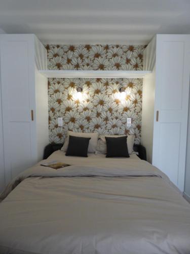 a bedroom with a large bed with two pillows at studio des olivières in Montpeyroux