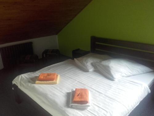 a bed with two towels on top of it at Hotel Anna in Harrachov