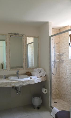 a bathroom with a sink and a shower at Villa Lefka in Kastrosikia