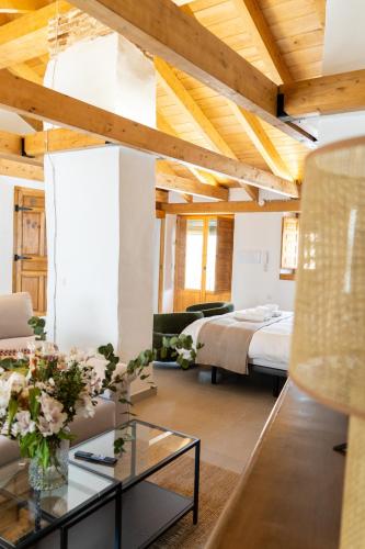 a living room with a bed and a table at Casa Molivez Apartamento Fabregas in Alhama de Granada