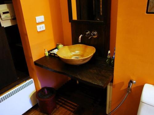 a bathroom with a wooden bowl sink on a counter at Haven Resort Paro in Paro