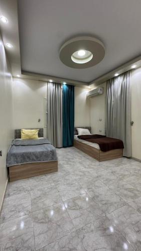 a bedroom with two beds and a ceiling at The Palace Dahab in Dahab