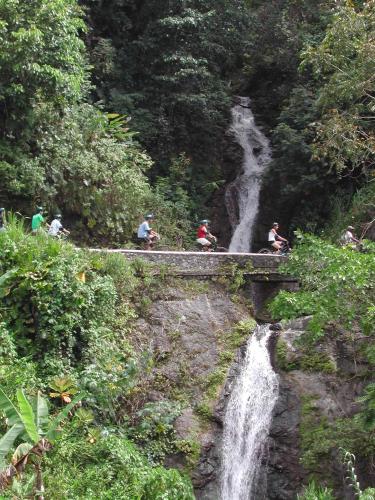 a group of people on a bridge over a waterfall at Moon San Villa at the Blue Lagoon in Port Antonio