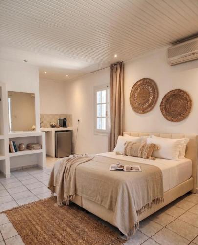 a bedroom with a large bed in a room at Physis Oikos Beachfront Apartments in Skiathos