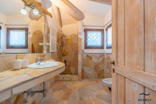 a bathroom with a sink and a toilet in it at Villa Domo Mea - By Searly in Porto Cervo