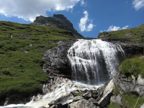 a waterfall on the side of a mountain at Apartments Krista in Seeboden