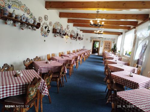 a dining room with red and white tables and chairs at Penzión ERIKA in Vysoké Tatry