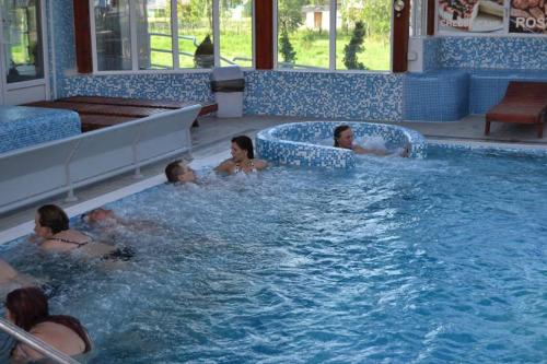 a group of people in a swimming pool at Sokoterme Hotel in Soko Banja