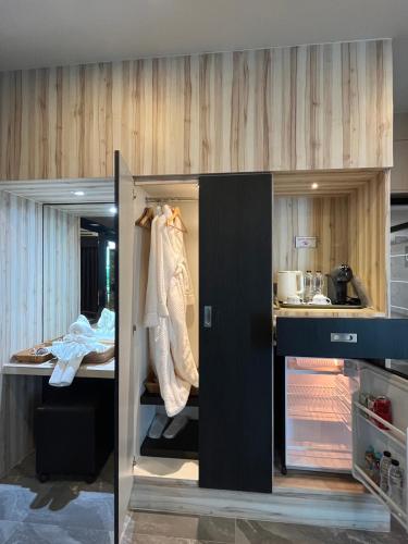 a room with a kitchen with a counter and a room with at The Room Boutique Hotel in Sakon Nakhon