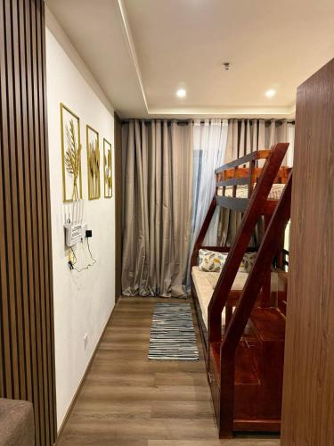 a small room with a bunk bed and a staircase at Bunker in Baguio