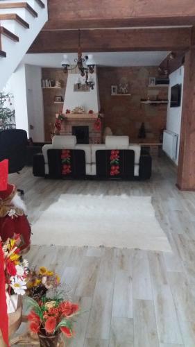 a large room with a table and chairs in it at Casa Bunicii in Moisei