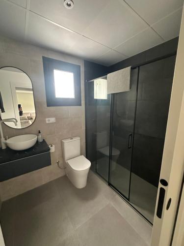 a bathroom with a toilet and a sink and a shower at La jaima in Santa Ceclina