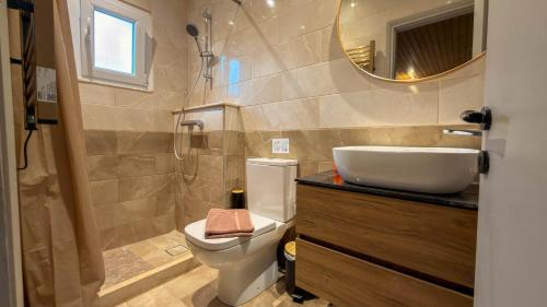a bathroom with a toilet and a sink and a mirror at Zografia View in Corfu