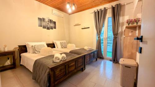 a bedroom with a large bed with towels on it at Zografia View in Corfu