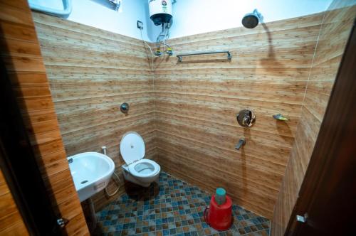 a bathroom with a toilet and a sink at Hotel Priyadarshini in Digha