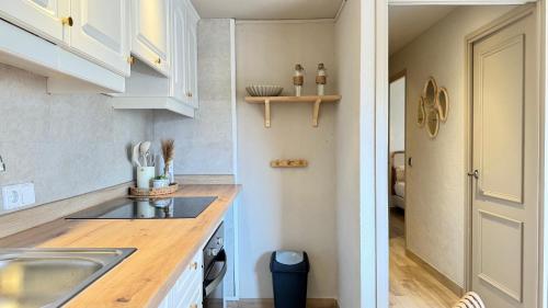a kitchen with white cabinets and a sink at Salles Beach 33 in L'Estartit
