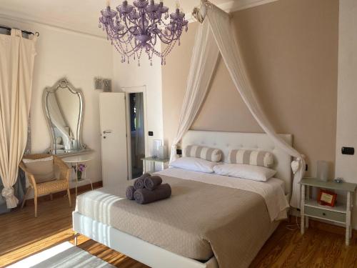 a bedroom with a large bed and a chandelier at Bed & Breakfast Lujocanda in Casarza Ligure