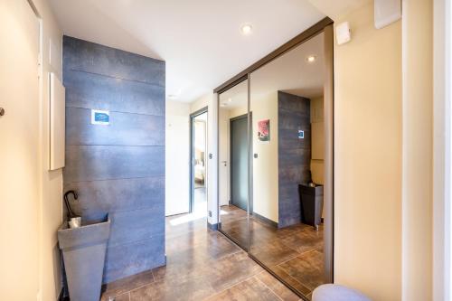 a pivot door in a hallway with a mirror at Le Princess in Évian-les-Bains