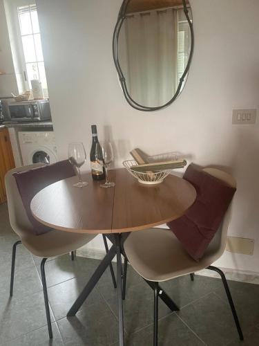 a dining room table with two chairs and a mirror at casa l'olivo in Forio d'Ischia