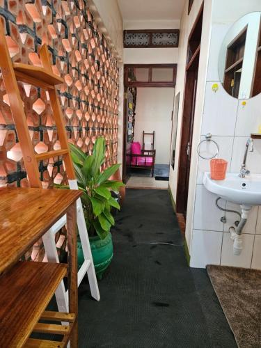 a hallway in a house with a sink at Aivilo Home in Entebbe