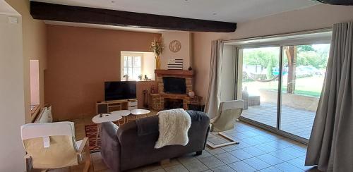 a living room with a couch and a table at Bryce Canyon in Châteaubourg